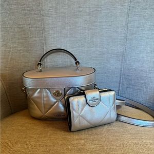 I am selling a small coach crossbody bag with the wallet, in a silver color.